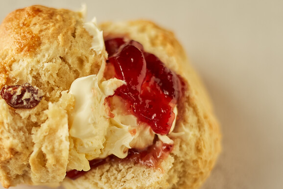 Close up of scone with jam and cream