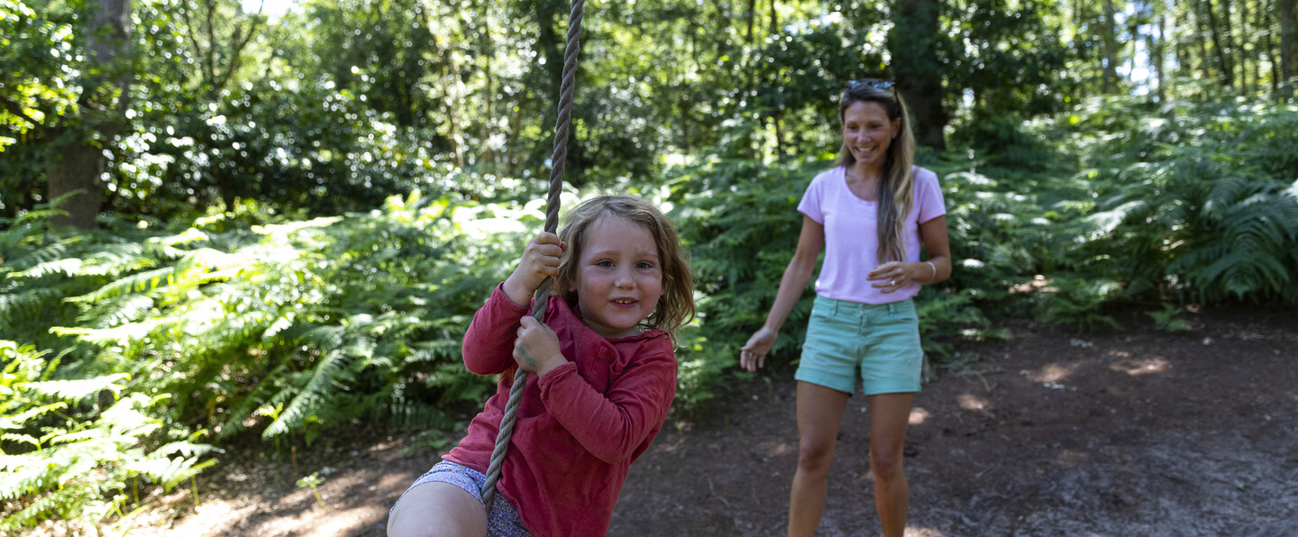 A mother and daughter play on a rope swing in the Verey Playwood