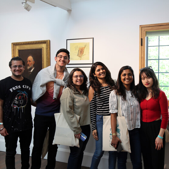 Group in Compton Gallery smiling to camera