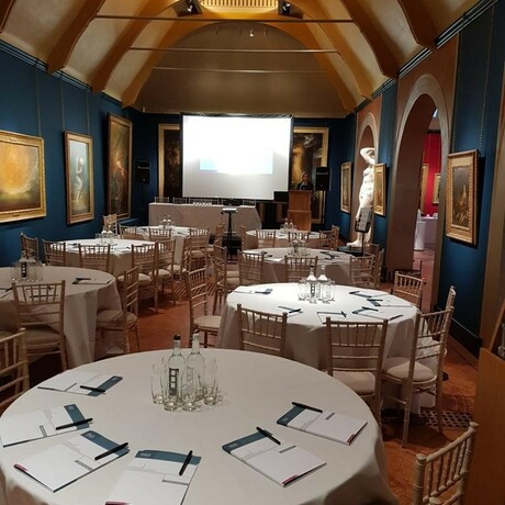 Laid tables with white table cloths in gallery