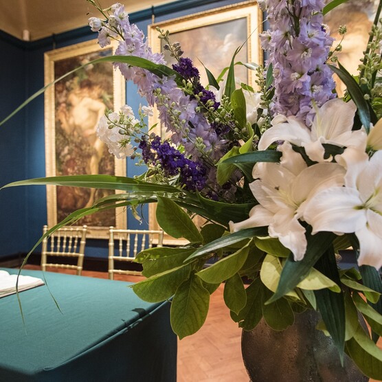 Lilies in vase set up for wedding ceremony