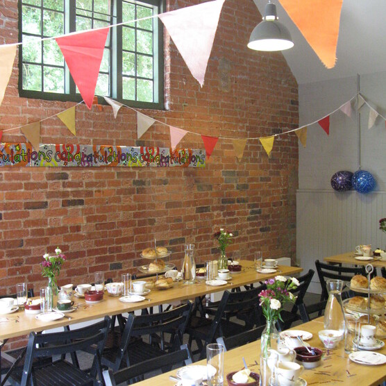 Tables laid with bunting hung around the room